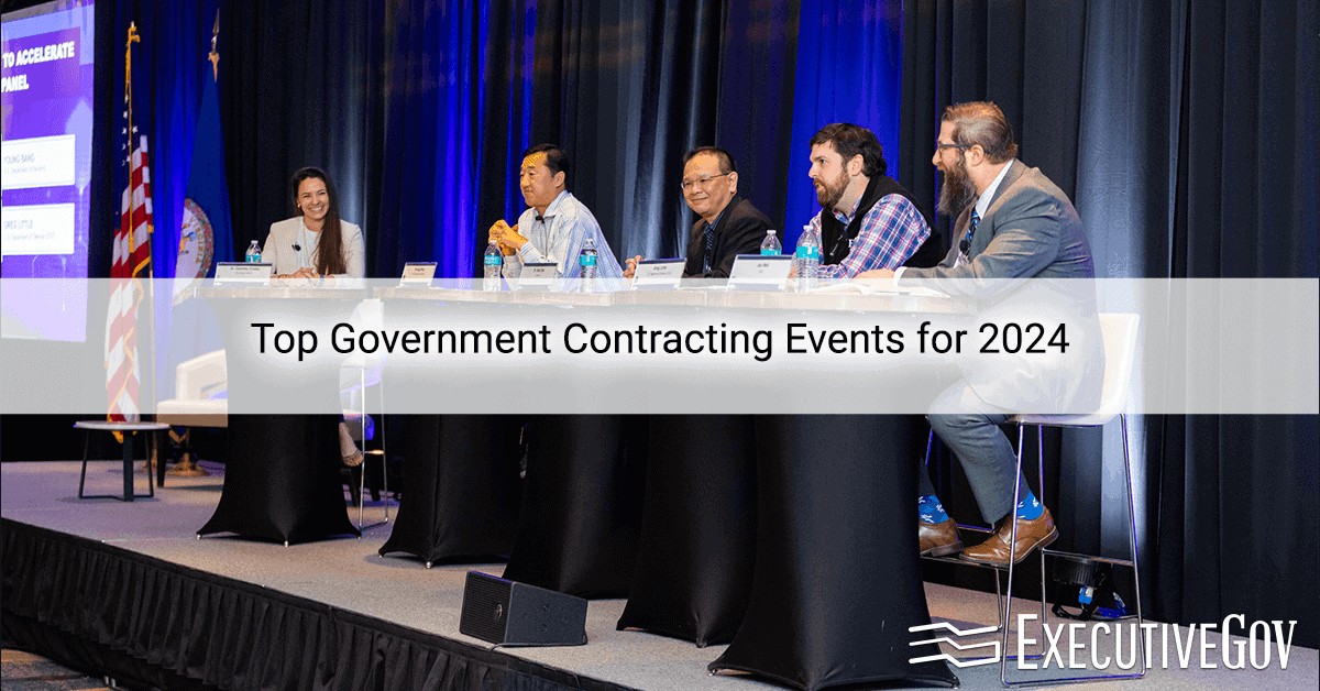 A group of business professionals on stage during a government contracting event