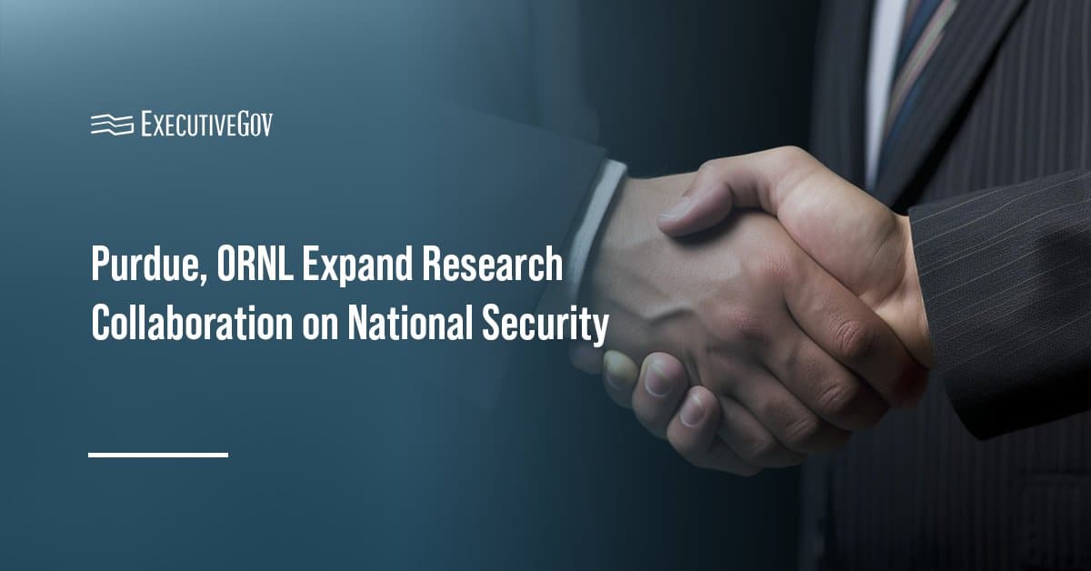 Handshake showing partnership. The Oak Ridge National Laboratory and Purdue University signed a memorandum of understanding.