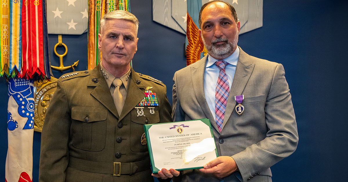 Gen. Christopher Mahoney and Mario Roberts. Mahoney and Roberts during a Purple Heart awarding ceremony